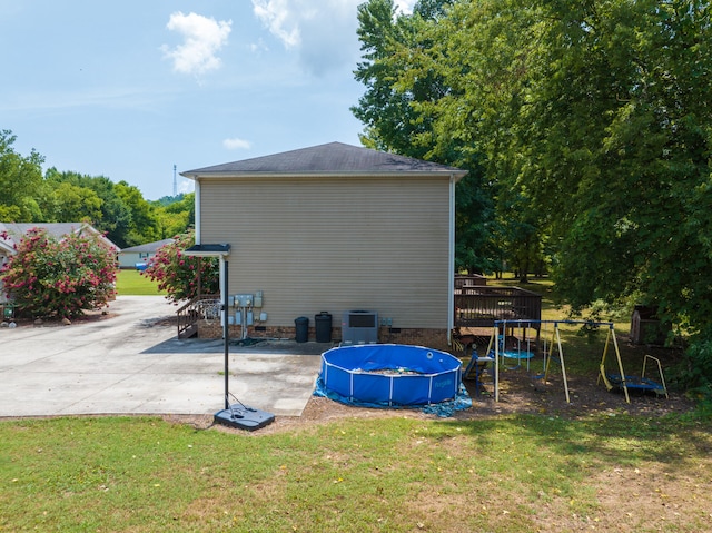 view of outbuilding featuring cooling unit and a yard