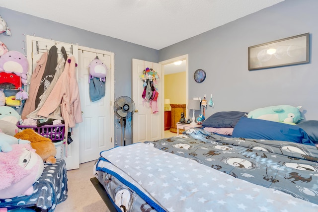 bedroom featuring light carpet and a textured ceiling