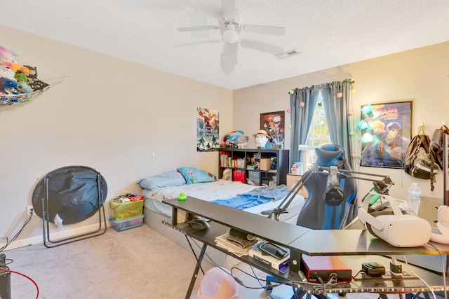 carpeted bedroom featuring a textured ceiling and ceiling fan