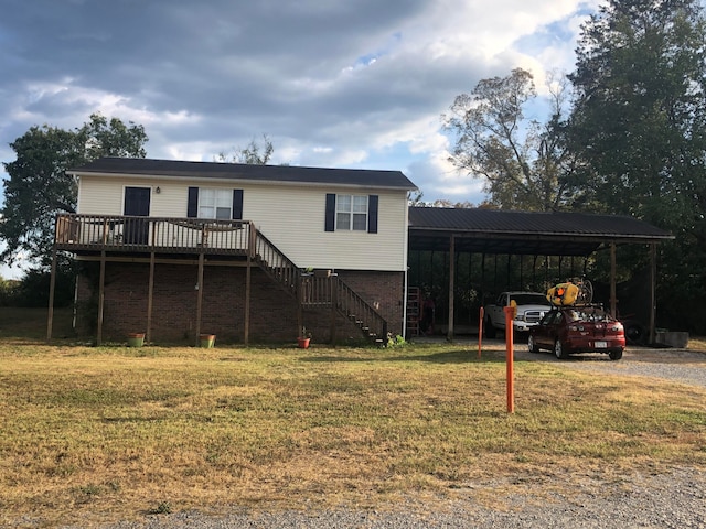 view of front of home with a deck and a front lawn