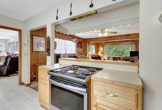 kitchen featuring light brown cabinets, ceiling fan, and electric range