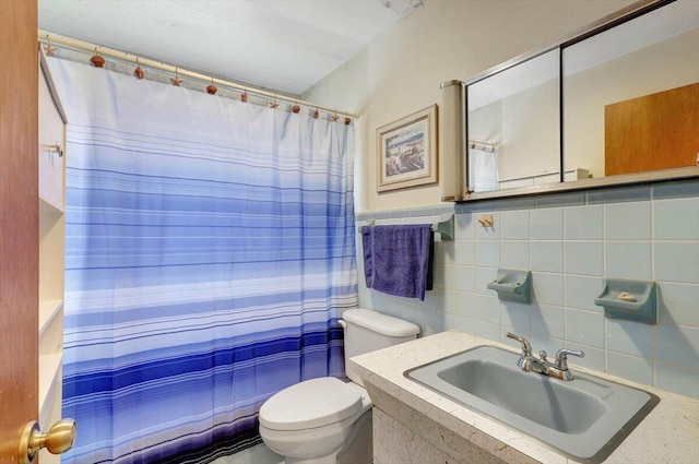 bathroom featuring toilet, vanity, tile walls, and a shower with shower curtain