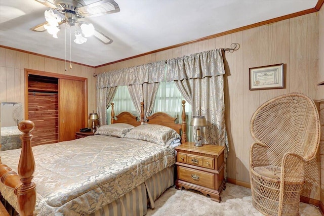 carpeted bedroom with ornamental molding, a closet, and ceiling fan