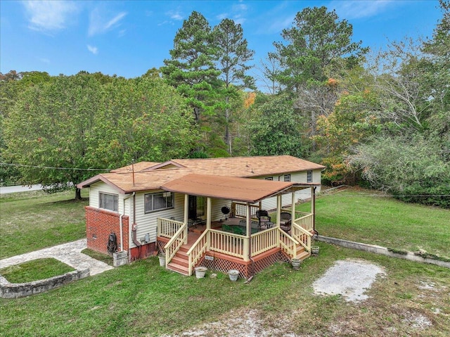 view of front of property featuring a front lawn and a deck