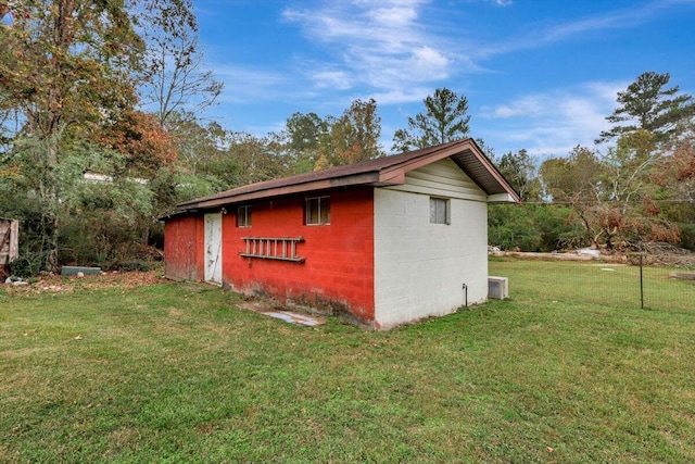 view of outbuilding with a yard