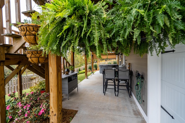 view of patio with a fenced backyard and outdoor dry bar