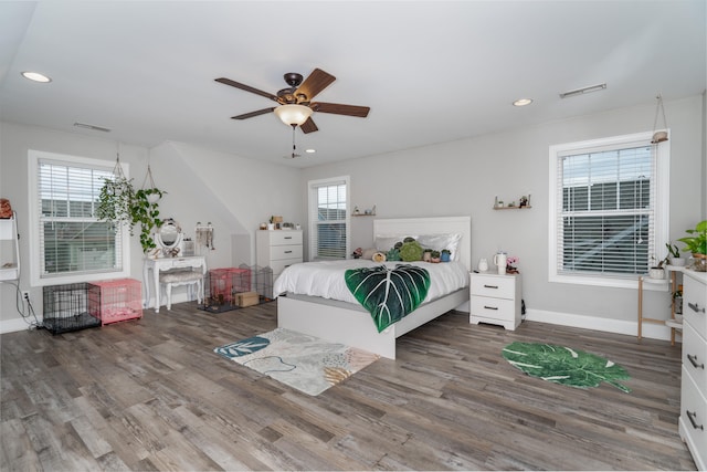 bedroom featuring multiple windows, visible vents, wood finished floors, and recessed lighting