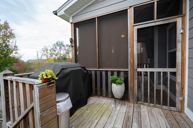 wooden terrace featuring a grill