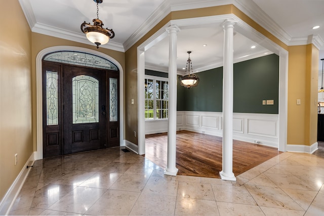 entryway featuring decorative columns, light hardwood / wood-style floors, and crown molding