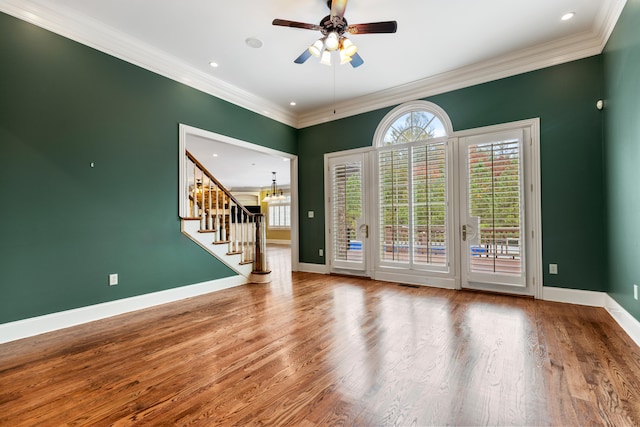 spare room with hardwood / wood-style floors, ceiling fan, and crown molding