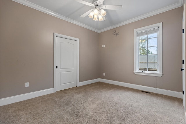 unfurnished room with carpet flooring, ceiling fan, and crown molding