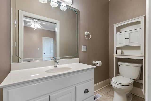 bathroom with crown molding, vanity, tile patterned flooring, toilet, and ceiling fan