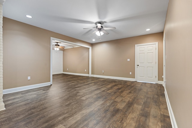 spare room with dark hardwood / wood-style flooring and ceiling fan