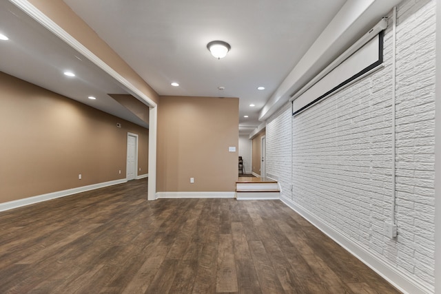 basement with dark hardwood / wood-style flooring