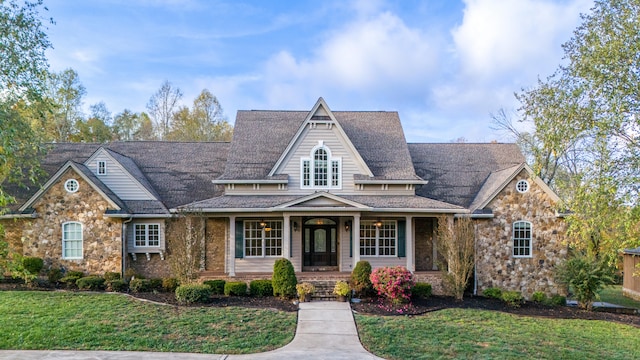 view of front of house with a front yard and covered porch