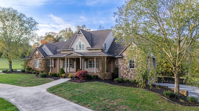 view of front facade with a porch and a front lawn