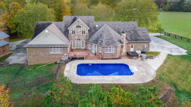 view of swimming pool featuring a patio, a yard, and a deck