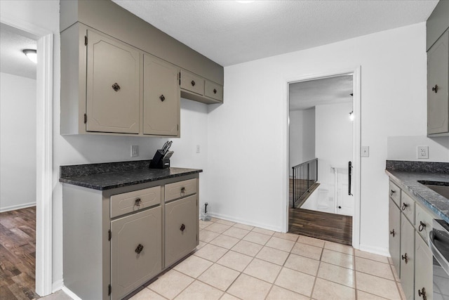 kitchen featuring gray cabinets, a textured ceiling, and light hardwood / wood-style floors