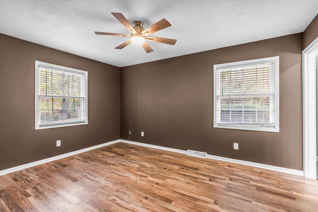 spare room featuring ceiling fan, a textured ceiling, and light hardwood / wood-style flooring