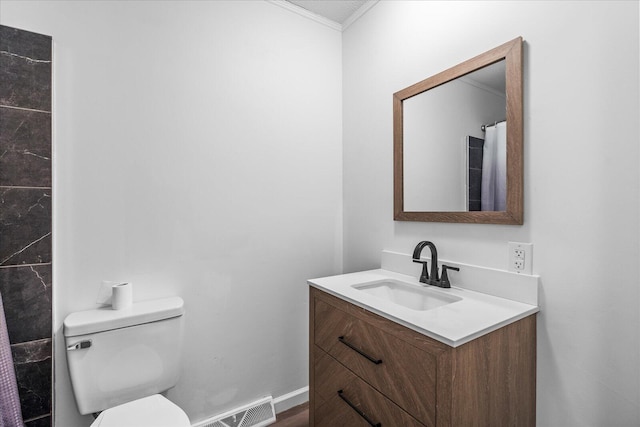 bathroom featuring vanity, toilet, and ornamental molding