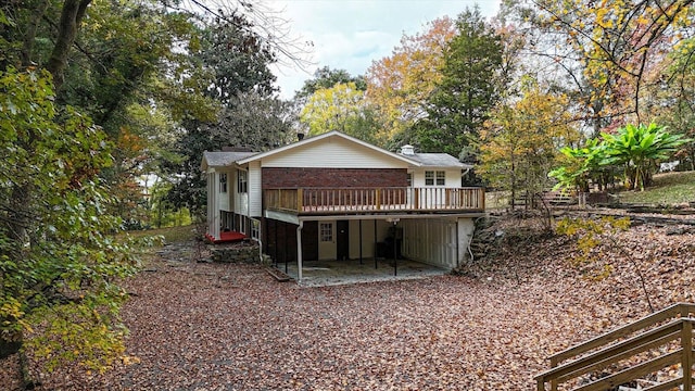 back of house featuring a wooden deck