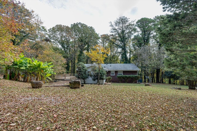 view of yard featuring a wooden deck