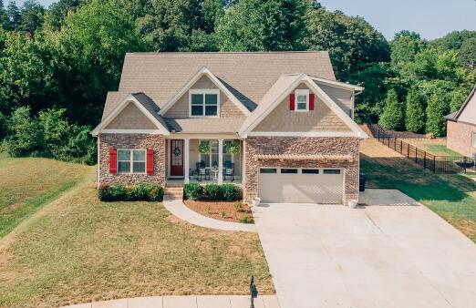 craftsman inspired home featuring a front yard and a garage