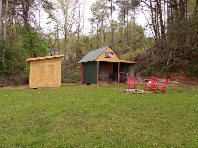 view of yard with a fire pit and a shed