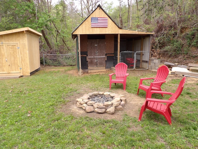 view of yard with an outdoor fire pit and a storage shed