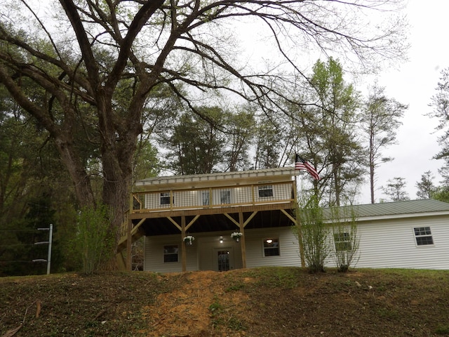 back of house featuring a wooden deck