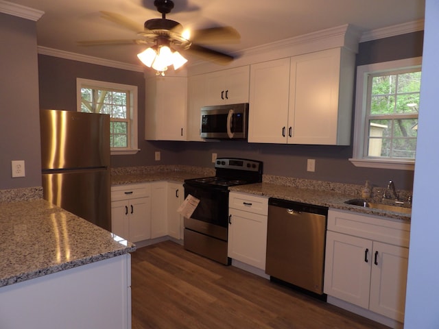 kitchen featuring sink, light stone countertops, white cabinets, and appliances with stainless steel finishes