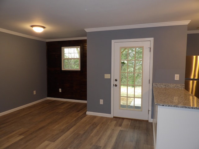 doorway to outside with dark wood-type flooring, plenty of natural light, and ornamental molding