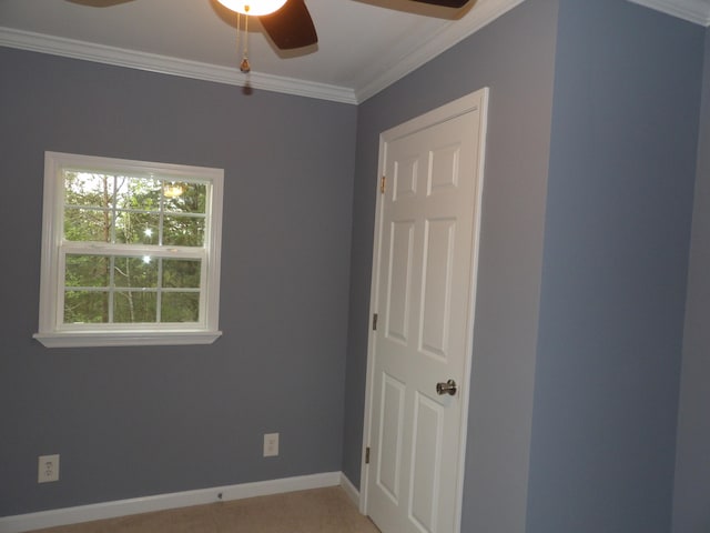 empty room featuring crown molding, carpet, and ceiling fan