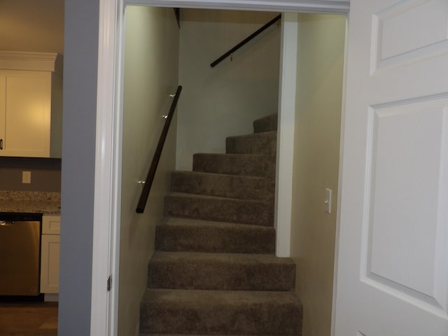 stairs featuring hardwood / wood-style flooring