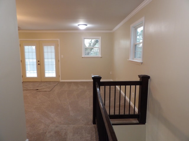 interior space with ornamental molding, french doors, and carpet flooring