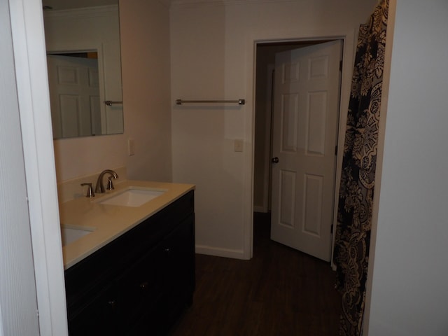 bathroom with hardwood / wood-style floors, vanity, and crown molding