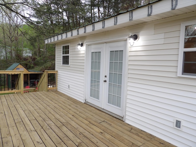 deck featuring a playground and french doors