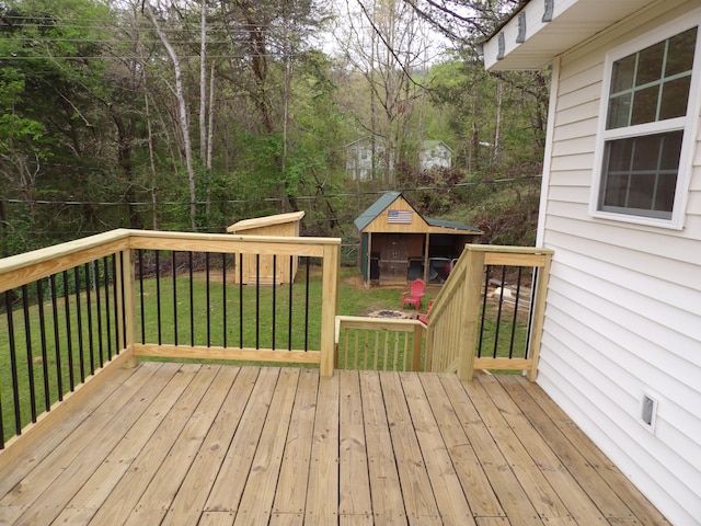 wooden terrace featuring a lawn