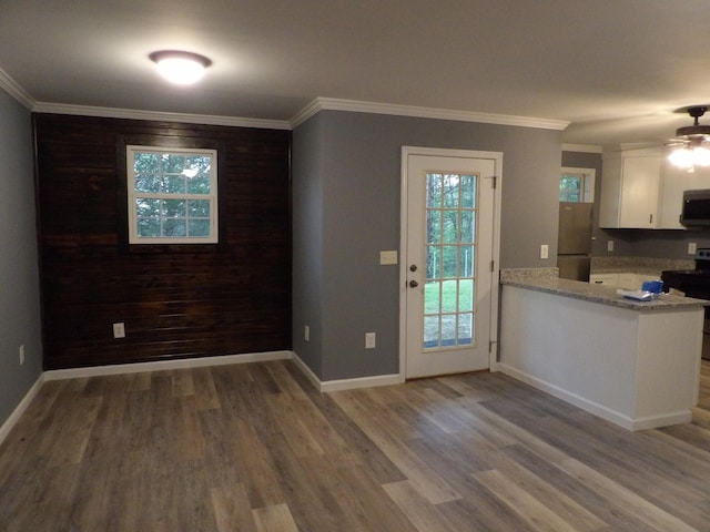 kitchen with white cabinets, crown molding, and appliances with stainless steel finishes