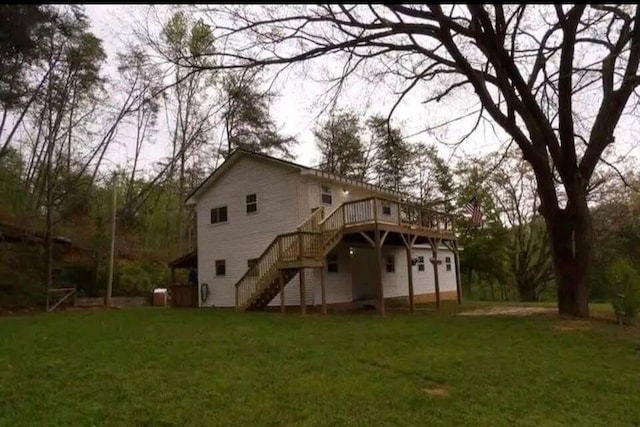 back of house with a deck and a lawn