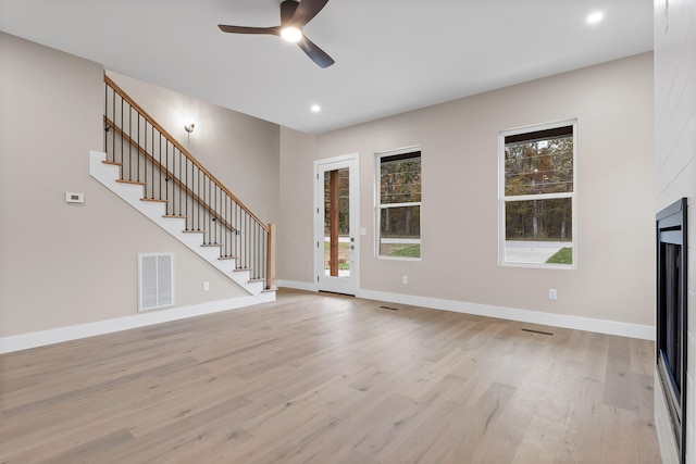 unfurnished living room with ceiling fan and light hardwood / wood-style flooring