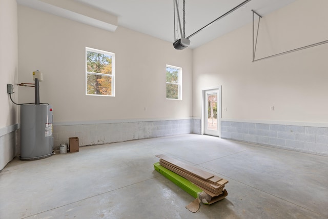 garage featuring a garage door opener and electric water heater