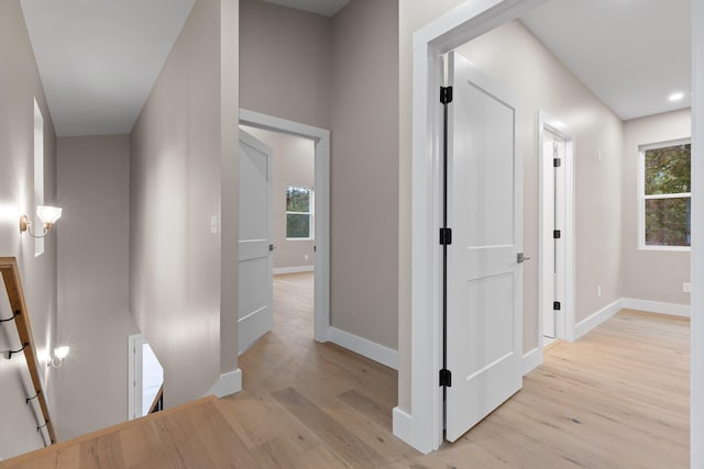 corridor with light hardwood / wood-style floors