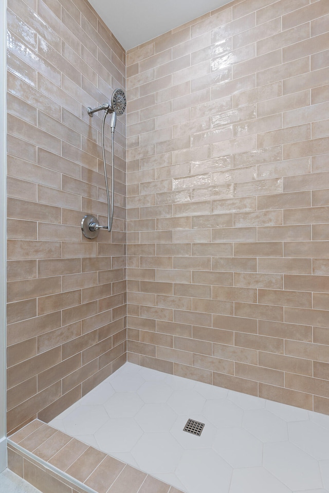 bathroom with tiled shower