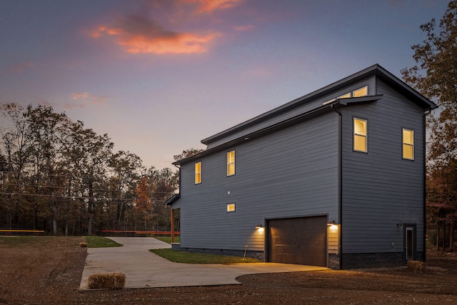 property exterior at dusk with a garage