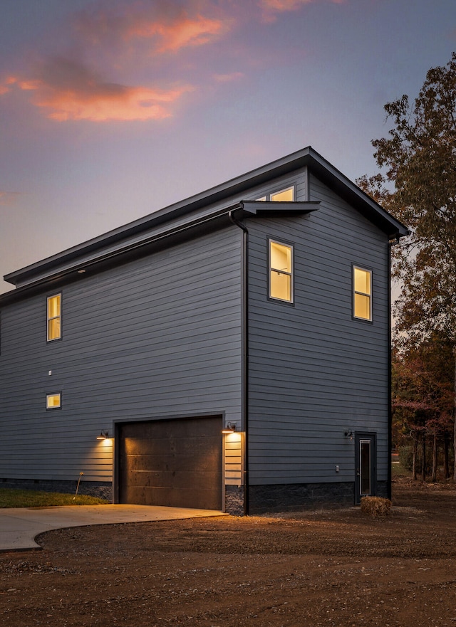 property exterior at dusk with a garage