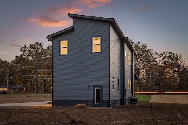 view of back house at dusk