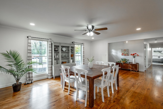 dining area featuring hardwood / wood-style flooring, a healthy amount of sunlight, ceiling fan, and crown molding