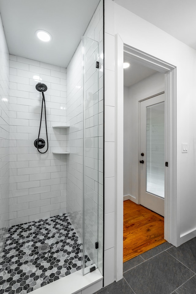 bathroom featuring an enclosed shower and hardwood / wood-style flooring