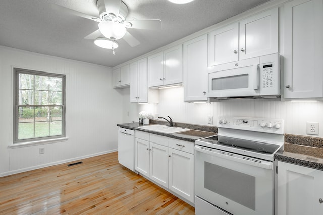 kitchen featuring white cabinetry, sink, light hardwood / wood-style floors, white appliances, and ceiling fan